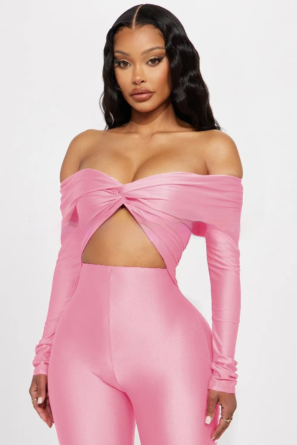 Women's pink V-neck long sleeve high waist jumpsuit with exposed midriff.