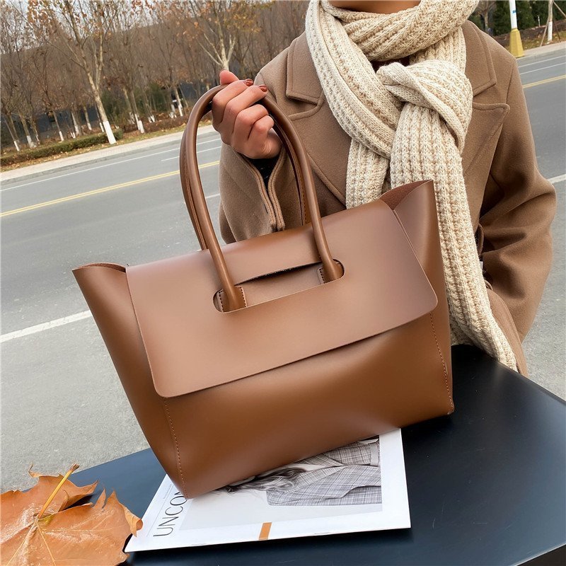 Large capacity brown shoulder bag with unique design and high-quality PU material.