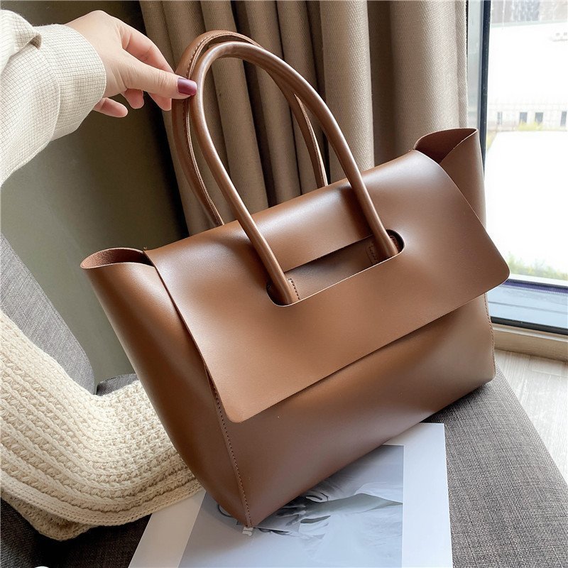 Large brown shoulder bag with single strap and sleek design, offering ample capacity and high-quality PU material.