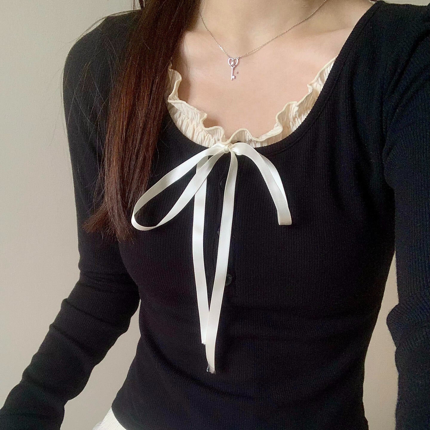 Black sleeveless Pure Desire Lace Inner Match Bottoming Shirt with white bow and lace neckline.