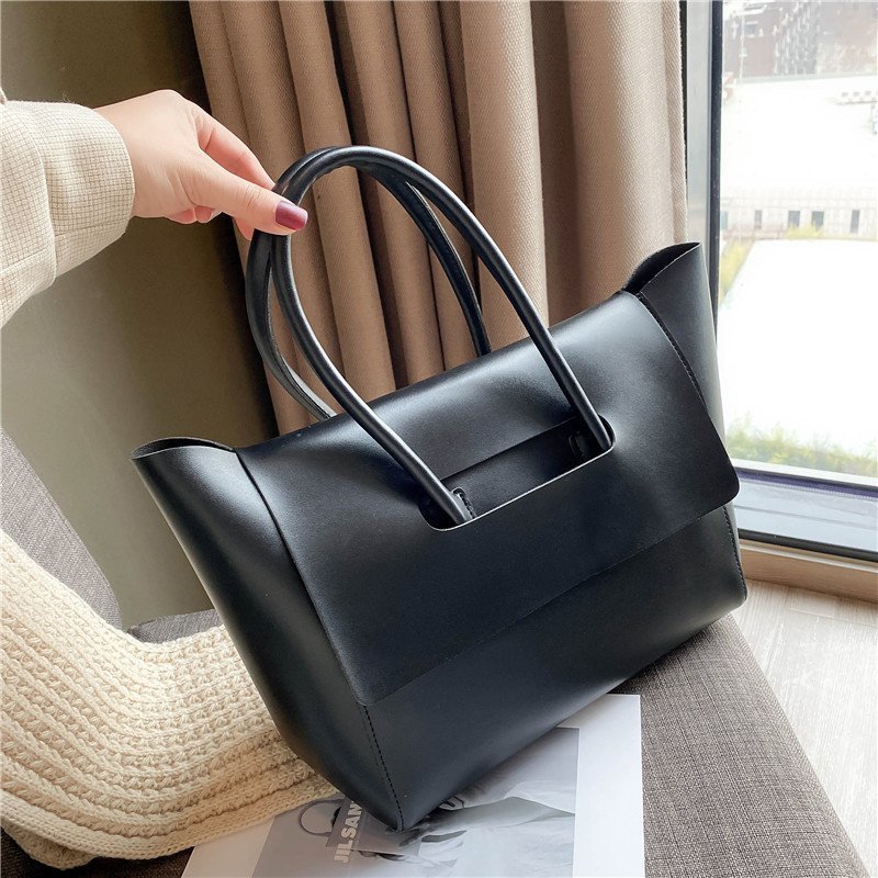 Large black shoulder bag with modern design and ample capacity.