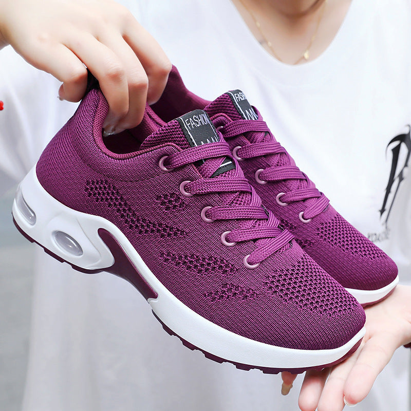 Women's purple breathable air cushion running shoes with mesh upper.