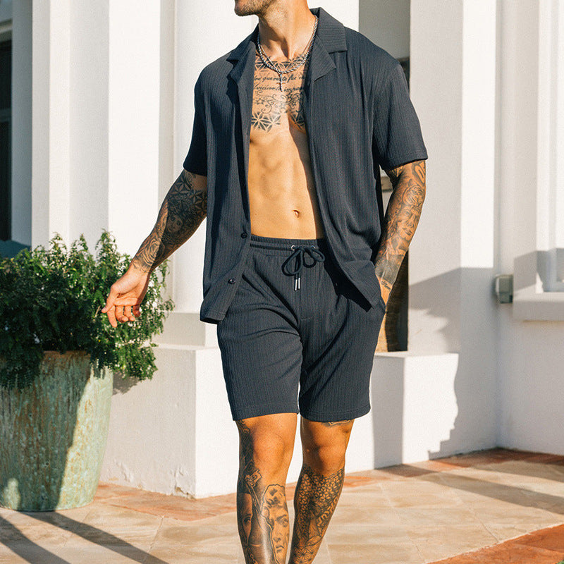 Men's black two-piece set with short sleeve shirt and shorts in a stylish, comfortable design.