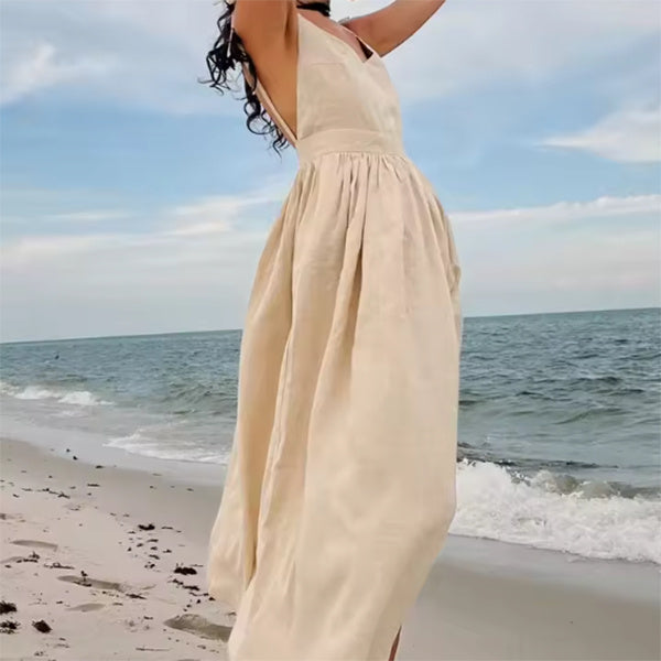 Summer V-neck high waist long dress in beige on the beach.