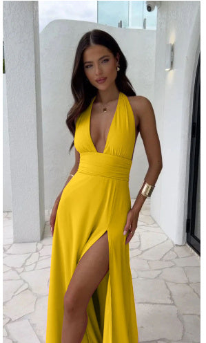 Halterneck V-neck slit dress in yellow with a high waist and sleeveless design.