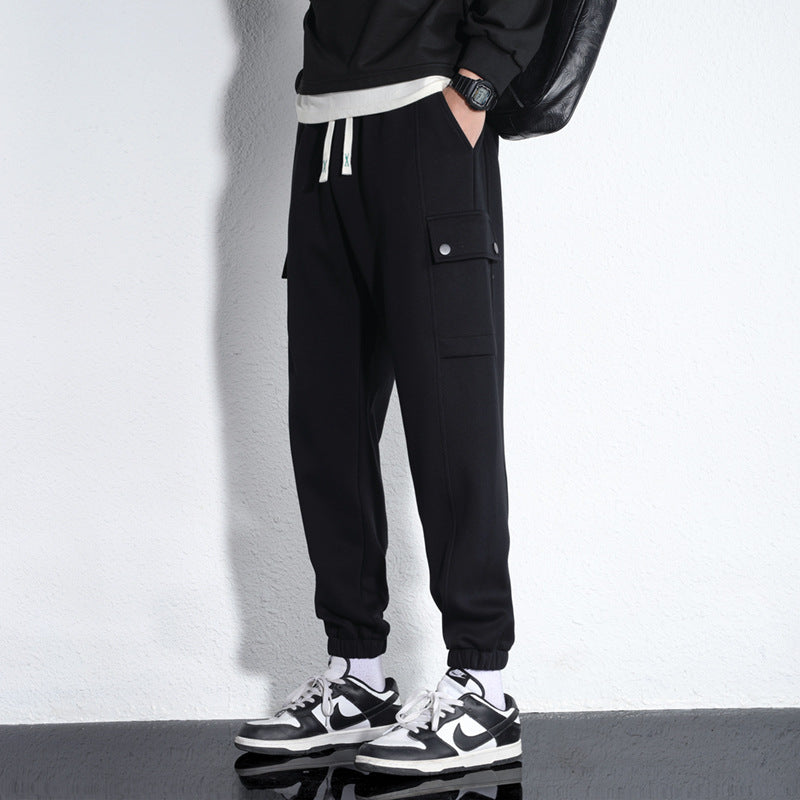 Men's black sports knitted cotton casual trousers with drawstring waist and side pockets.