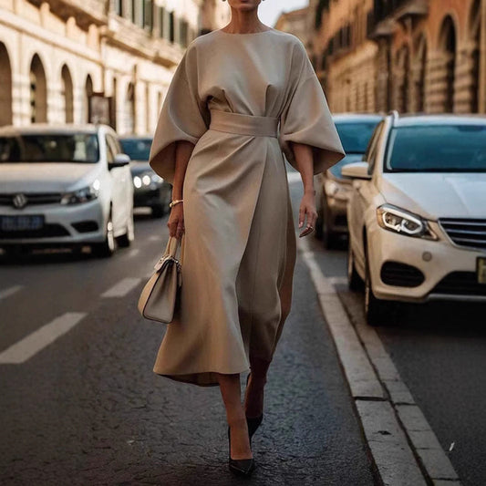 Loose batwing sleeve dress in urban fashion setting, stylish and comfortable with belt detail.