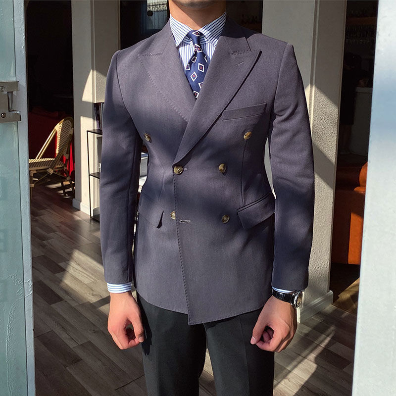 Casual business all-match double-breasted suit jacket in dark color, worn by a person indoors.